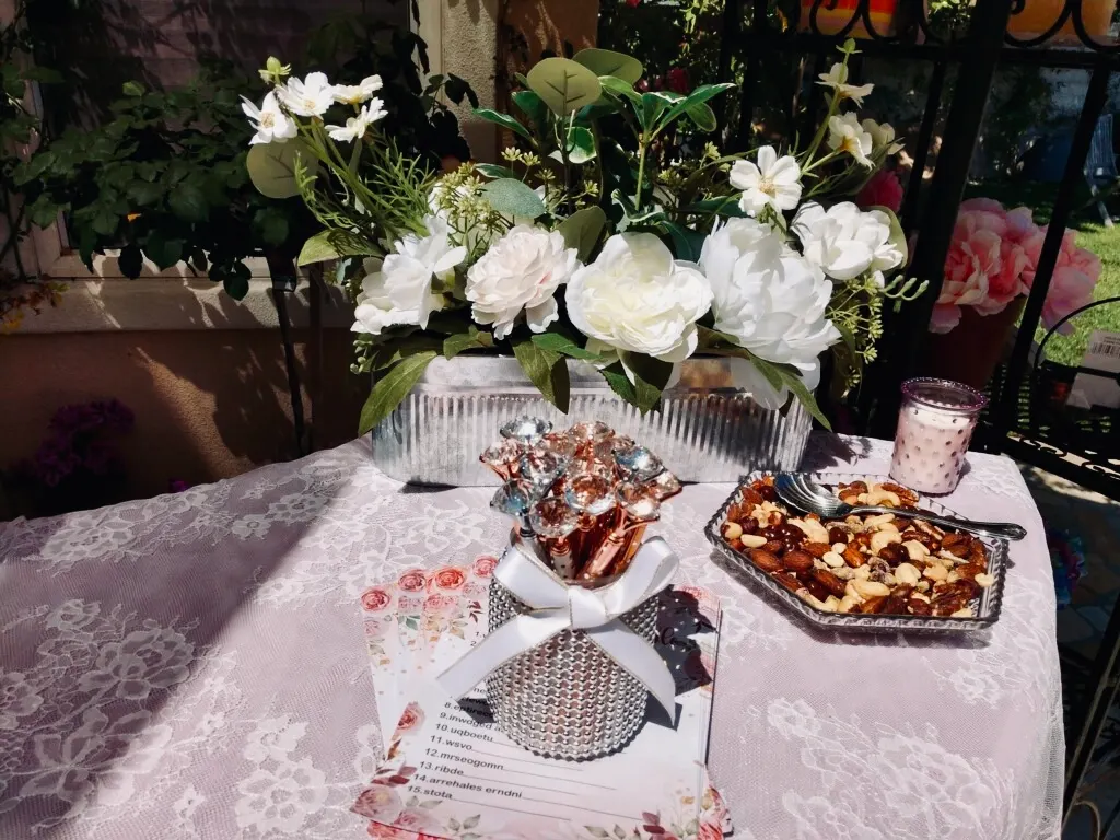 Dessert table styled with white and pink florals and a gluten-free dessert spread