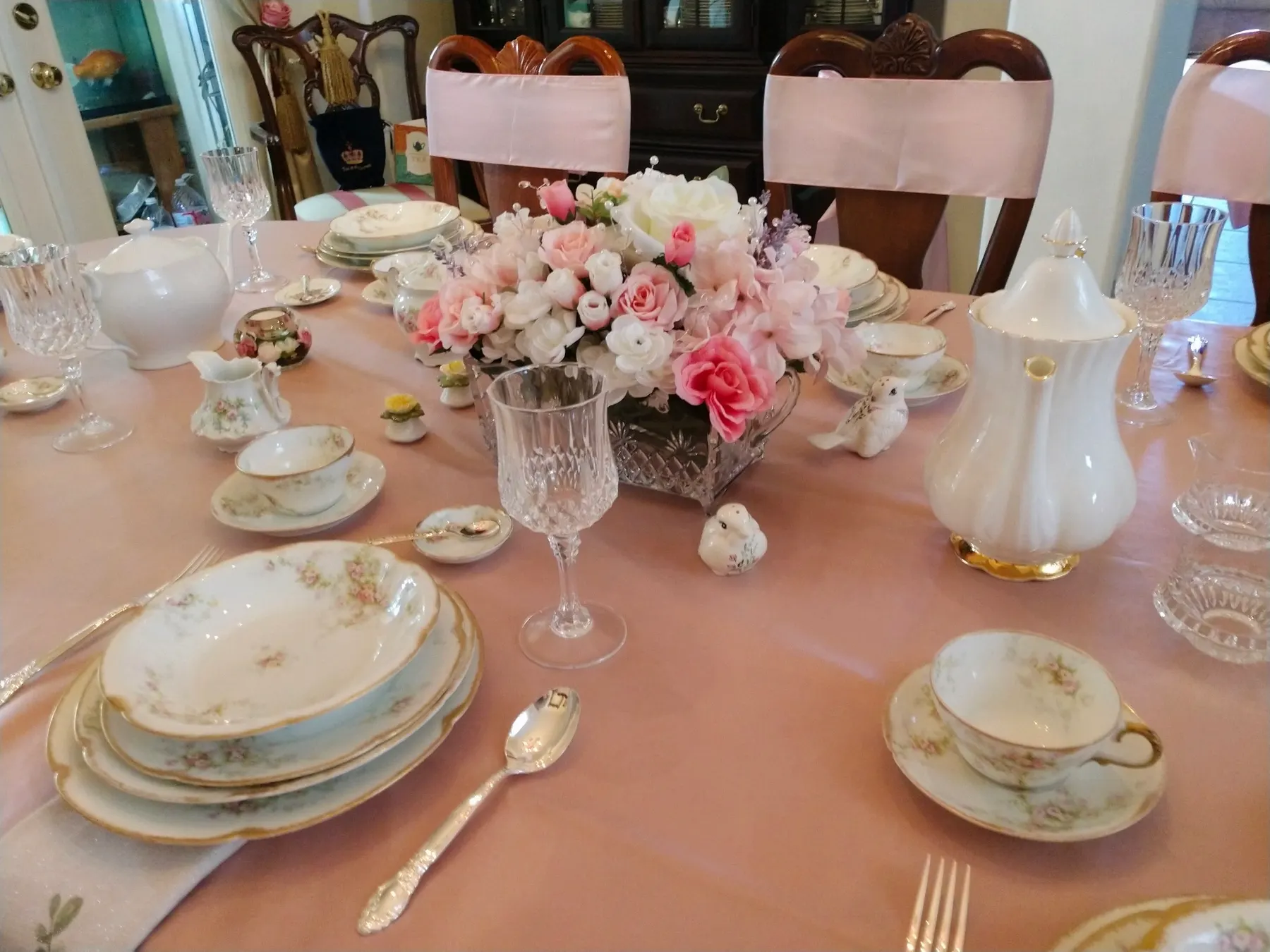 Long dining table styled with peonies, vintage china and gold-rimmed place settings for a gluten-free celebration