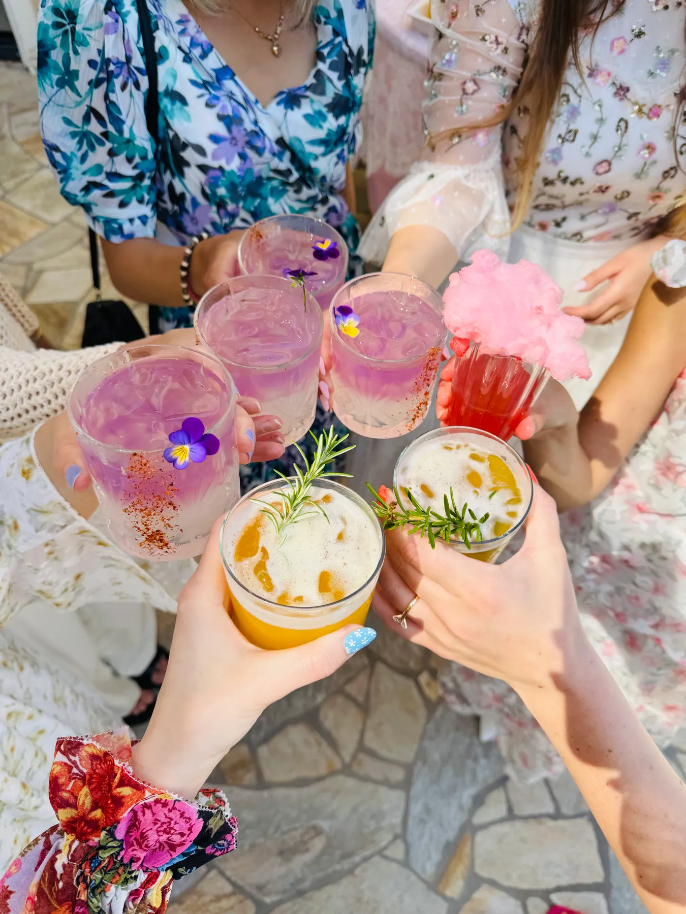 Guests raising a toast with garnished mocktails at a gluten-free celebration